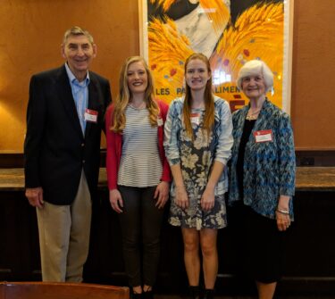 Max and Jeanne Spilde Gonzenbach take a photo with two of the scholarship recipients, Morgan McAllister and Samantha Hyronimus.