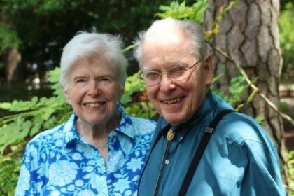 Dr. René and Marilyn Grace standing together in front of a tree.